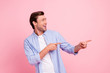 © deagreez - Portrait of nice attractive handsome cheerful cheery guy wearing checked shirt pointing two fingers aside isolated over pink pastel background