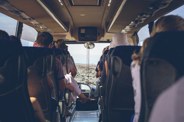 the tourist bus interior with people sitting