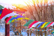 Buddhist tibetan prayer flags is flying on wind on background of trees. Sunlight visible through numerous colorful prayer flags.