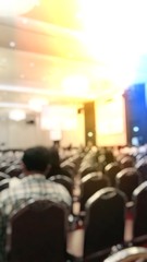 Abstract blurred image of people in seminar room or conference hall for profession seminar and the speaker is presenting new technology with the content activity. education and business concept