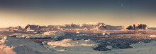 Sunset Mountain Panorama Of Antarctica. The Stunning Sepia Tone Landscape. The Sunlit Antarctic Bay Under The Crystal Clear Sky. The Snow Covered Polar Surface Next To The Frozen Ocean. Winter Scene.