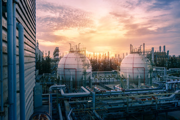 Gas storage sphere tanks and pipeline in petrochemical industrial plant on sky sunset background, Manufacturing of petroleum industry plant