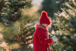 © RooM The Agency - Girl standing in a field choosing a Christmas tree, United States