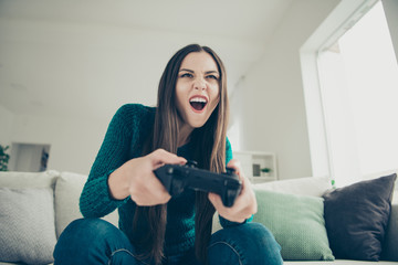 Low angle close up view photo portrait of pretty attractive charming nice lovely addicted mad with comic facial expression she her teen holding game pad in hands