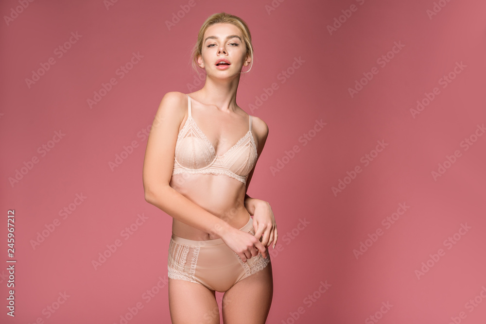 beautiful sensual girl posing in lingerie, isolated on pink - obrazy, fototapety, plakaty 
