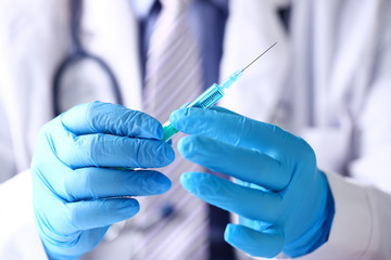 Sticker - Physician arms wearing protective blue gloves prepare syringe