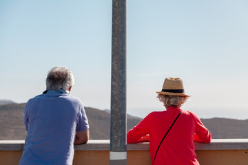 A man and a woman of retirement age are traveling.