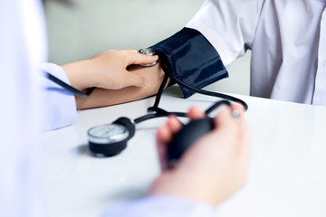 Doctor examines a patient with a stethoscope.