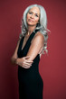 © Andreas Kuehn - Portrait of a beautiful woman with long, silvery, grey hair wearing a black evening dress.