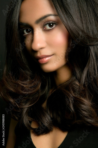 Young Indian Woman Wearing Her Wavy Shiny Dark Hair In A