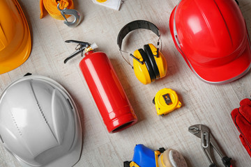 Sticker - Flat lay composition with tools and safety equipment on wooden background