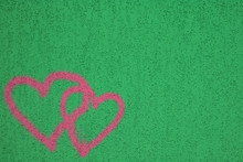 Two Graffiti Love Pink Heart Painted On Green Textured Wall