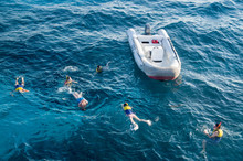Swimmers And Rescue Inflatable Boat In Sea In Hurgada