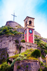 Wall Mural - beautiful landscape with a clock and bell tower in the old fortress in kerkira, corfu, greece. popul