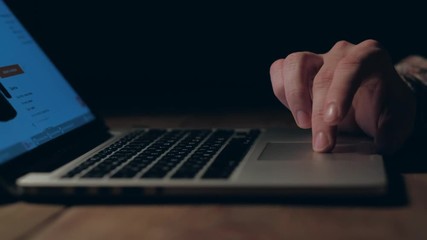 person chooses clothes on the internet at home using a laptop. online shopping concept. 4k.