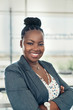 © JonoErasmus - Portrait of a beautiful smiling black businesswoman with her arms crossed