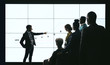 © JonoErasmus - Indian businessman pointing at digital screen during a presentation with team of people watching