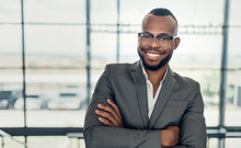 Portrait Of A Confident Black Businessman Smiling Holding With His Arms Crossed