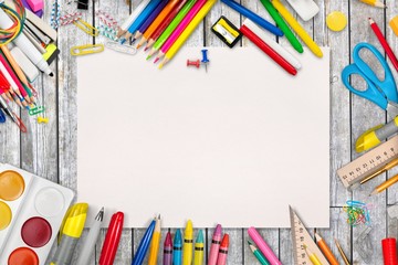 Colorful school supplies on wooden table background