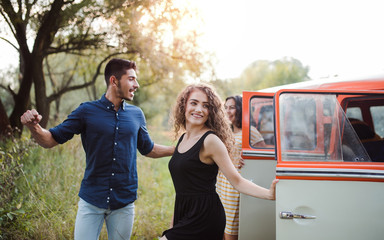 A group of young friends on a roadtrip through countryside.