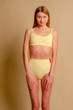 © Максим Галінский - young tanned blonde girl in lemon yellow swimsuit is standing like fitness model, attractive blond woman wearing a lemon-colored underwear posing for pictures in studio on beige background