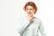© merrymirta - Beautiful red haired adult woman in casual looking into the camera with pensive expression, thinking or doubting about something on white background
