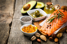 Selection Of Healthy Unsaturated Fats, Omega 3 - Fish, Avocado, Olives, Nuts And Seeds