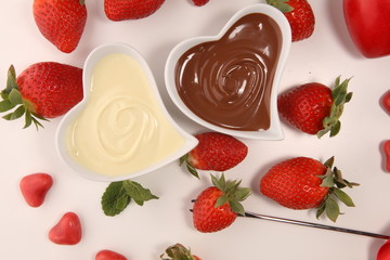 Wall Mural - Valentine Chocolate fondue melted with fresh strawberries and dark and white chocolate. Tublips and sugar hearts.