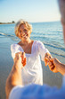 © Darren Baker - Happy Senior Couple Dancing Holding Hands on Sunset Beach