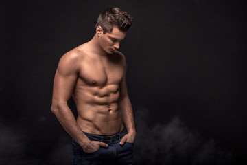 Handsome shirtless man in studio.