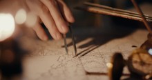 Different Views Of A Vintage 1850 Mapmaker Using A Compass Divider Going Over A Map Taking Notes
