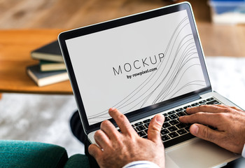 Wall Mural - businessman working on a laptop with a screen mockup