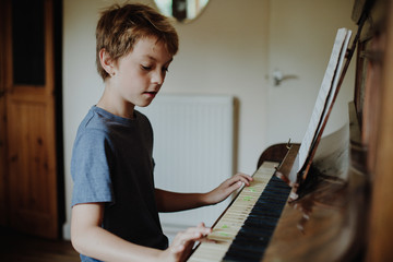 young boy playing the piano