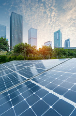 Wall Mural - ecological energy renewable solar panel plant with urban landscape landmarks