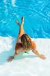 © Netfalls - Woman relaxing at the swimming pool at the luxury resort