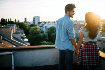 Couple in love enjoying in sunset in a terrace