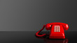 Red old vintage telephone on black background