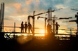 © Yuttana Studio - Silhouette of engineer and construction team working at site over blurred background for industry background with Light fair.Create from multiple reference images together