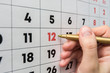 © madhourse - Hand marker indicates the 12th number in the wall calendar