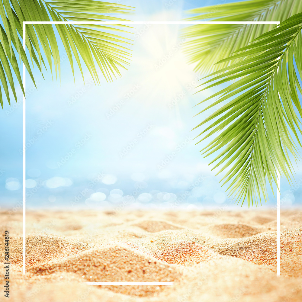 Summer background with frame, nature of tropical golden beach with rays of sun light and leaf palm. Golden sand beach close-up, sea water,  blue sky, white clouds. Copy space, summer vacation concept. - obrazy, fototapety, plakaty 