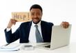 © SB Arts Media - Depressed sad and frustrated young businessman holding a help sign in stress at workplace