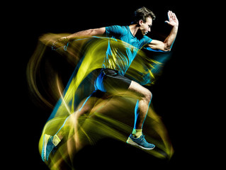 Wall Mural - one caucasian runner running jogger jogging man light painting speed effect isolated on black backgr
