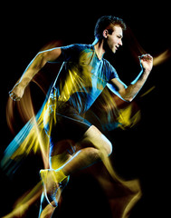 Wall Mural - one caucasian runner running jogger jogging man light painting speed effect isolated on black backgr