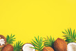 Bright yellow tropical background with coconuts