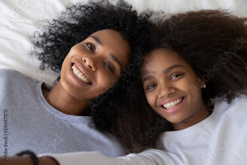 Smiling African American Mommy And Daughter Relax Together
