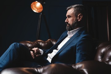 Wall Mural - Attractive man with cigar and a glass whiskey