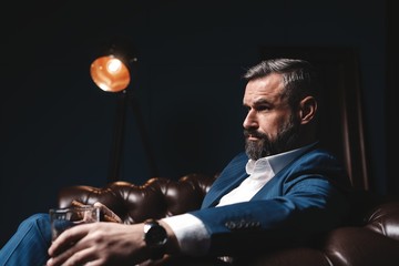 Wall Mural - Attractive man with cigar and a glass whiskey