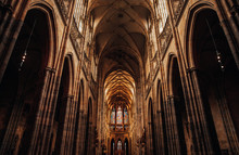 Interior Of Gothic Cathedral Inside. Carved Pulpit, Stained-glass Windows Through Which Light Rays Penetrate Building