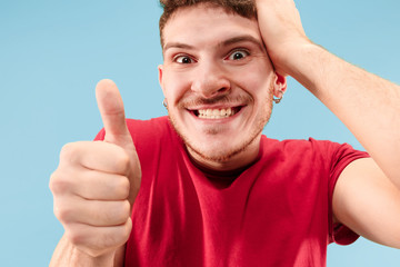 I won. Winning success happy man celebrating being a winner. Dynamic image of caucasian male model on blue studio background. Victory, delight concept. Human facial emotions concept. Trendy colors