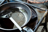 Fototapeta Do pokoju - Used dirty iron pan with oil and dirty turner and space for write wording, bad cooking behavior cause of illness and health problem and financial problem to family such as cancer, digestive illness